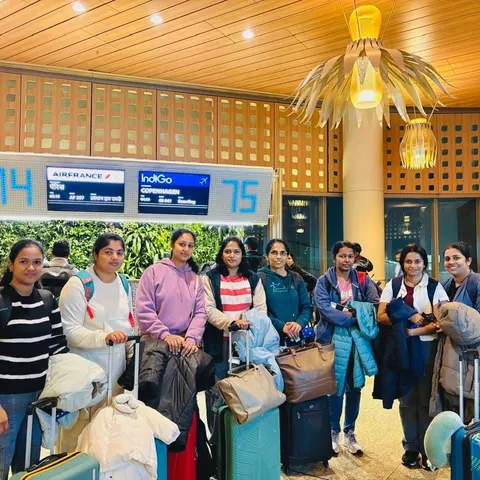 Group of women with luggage at an airport departure gate