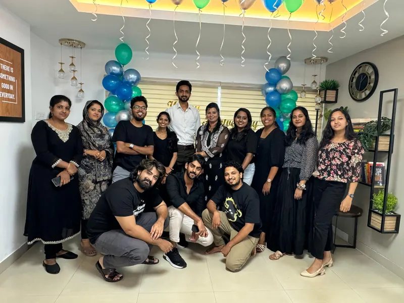 Mount Bell team at an office celebration with blue and green balloons