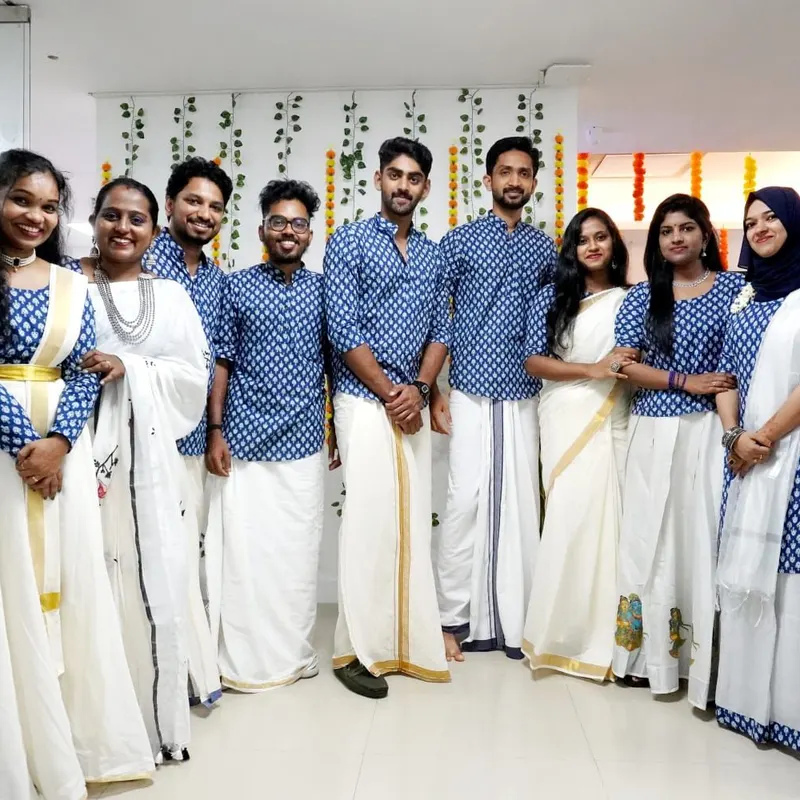Mount Bell team in matching blue and white Kerala dress at the office