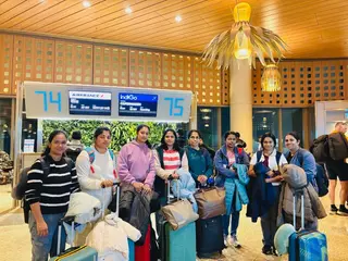 Group of women with luggage at an airport departure gate